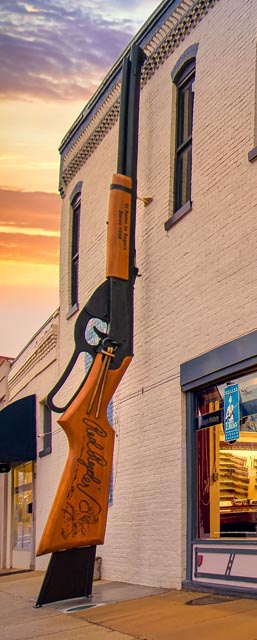 Close-up of the 25-foot Daisy BB Gun sculpture at sunset